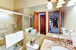 Bathroom with granite counter and bathtub